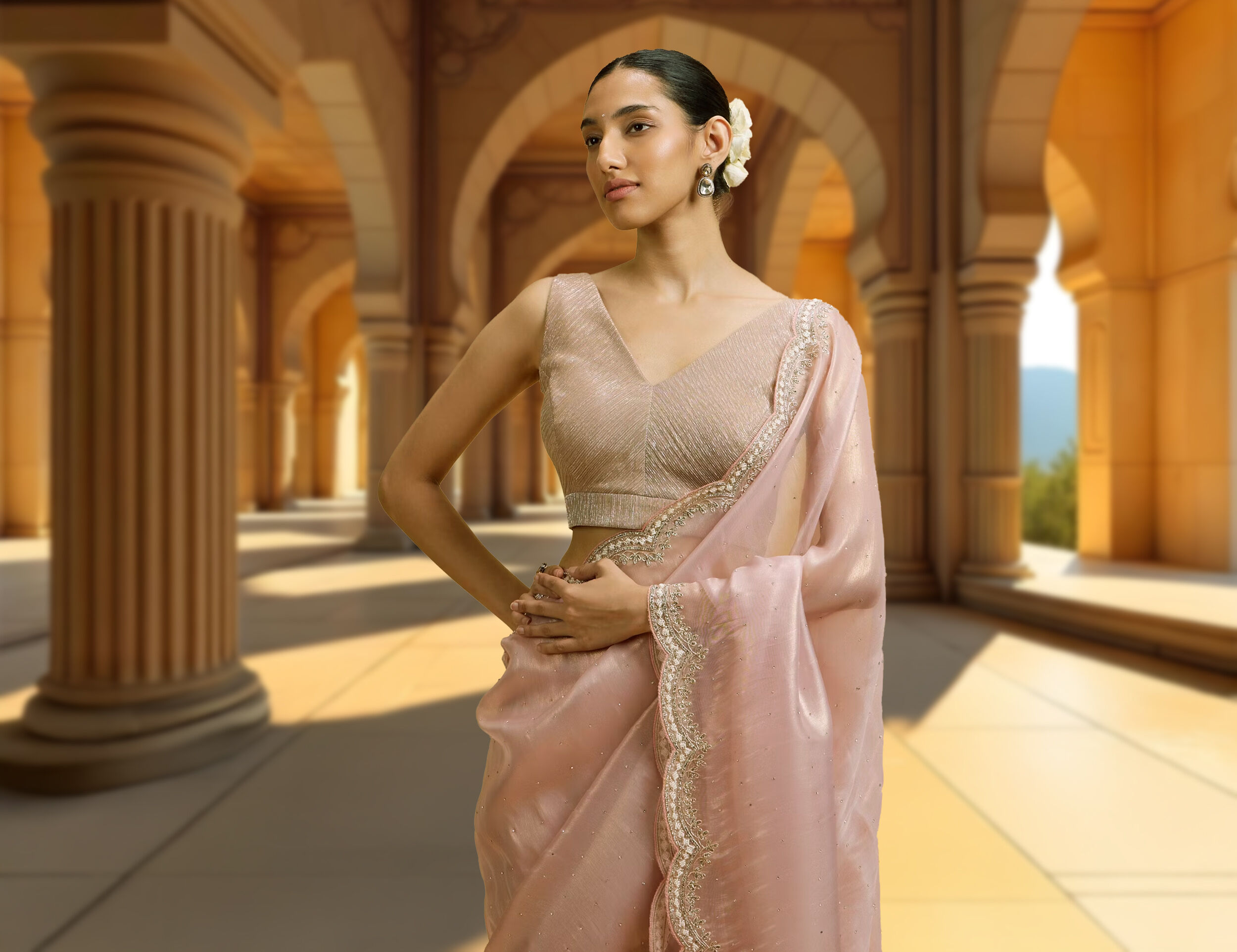 Graceful woman draped in a light pink saree paired with a beautifully designed gold blouse, perfect for a bridal look.